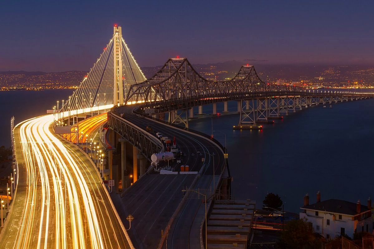 Traffic light trails on the new Bay Bridge eastern span beside the old span