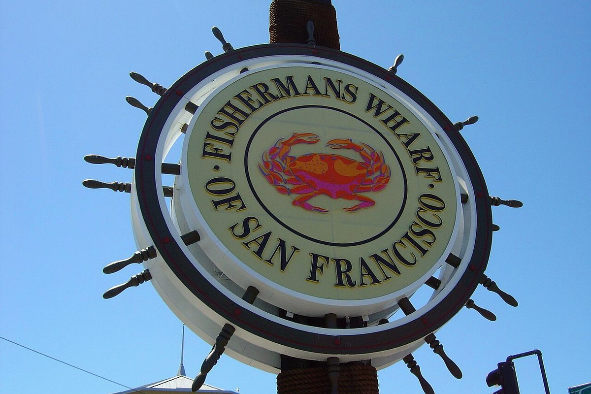 The Fisherman's Wharf sign in San Francisco against a blue sky