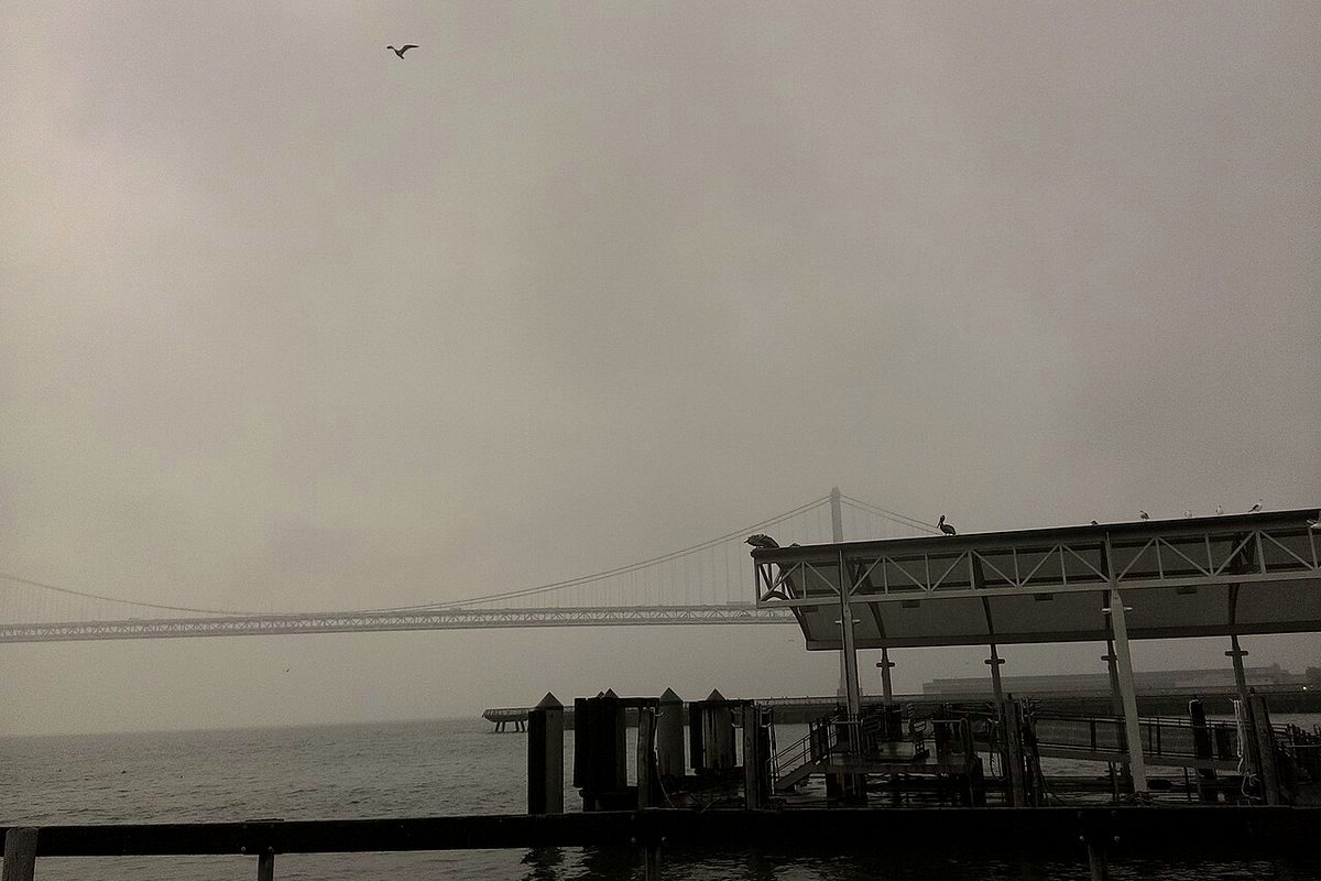 Grey, overcast skies over San Francisco Bay and the Bay Bridge