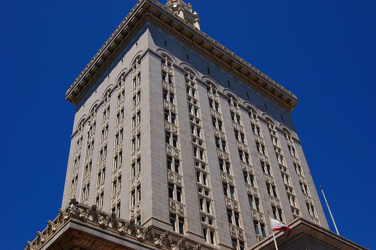 Oakland City Hall tower against a deep blue sky