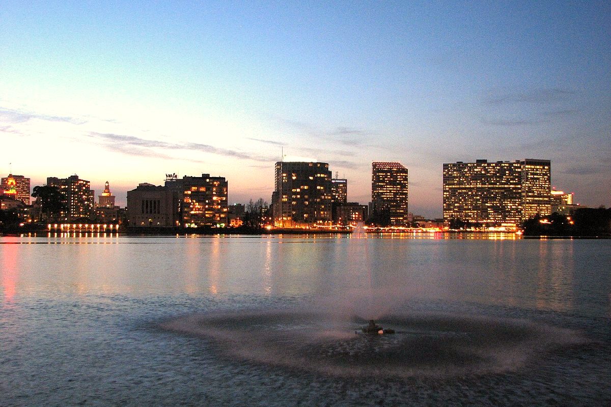 Downtown Oakland skyline over Lake Merritt at dusk