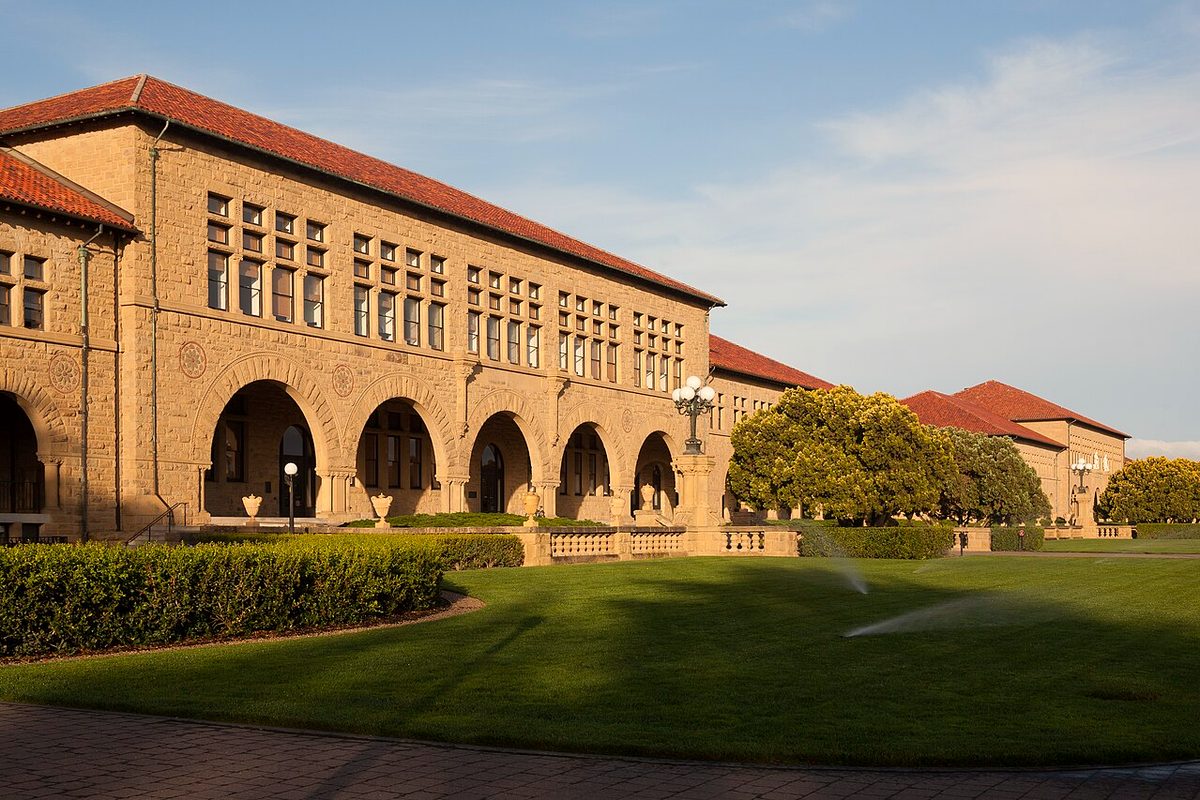 Sandstone arcades of Stanford University's Main Quad in afternoon sun